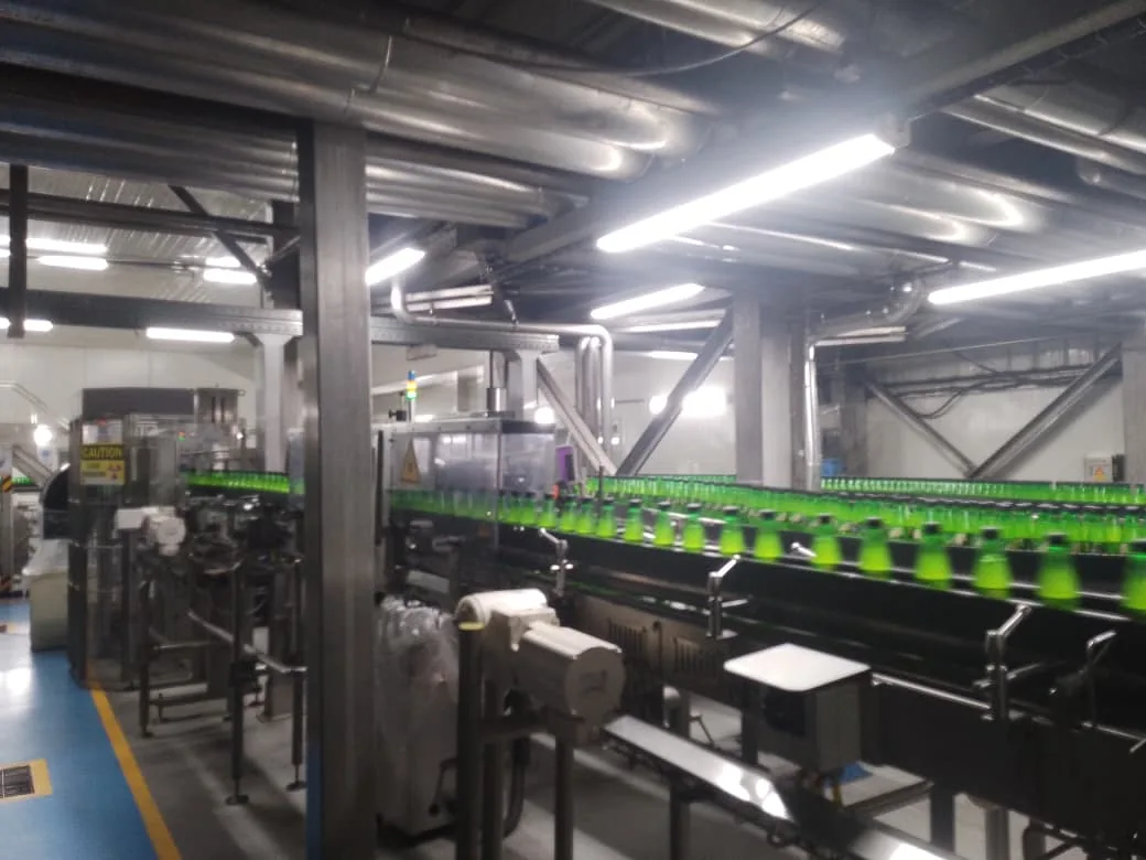 Lotte Akhtar Beverages facility hall with processing equipment under ceiling lighting