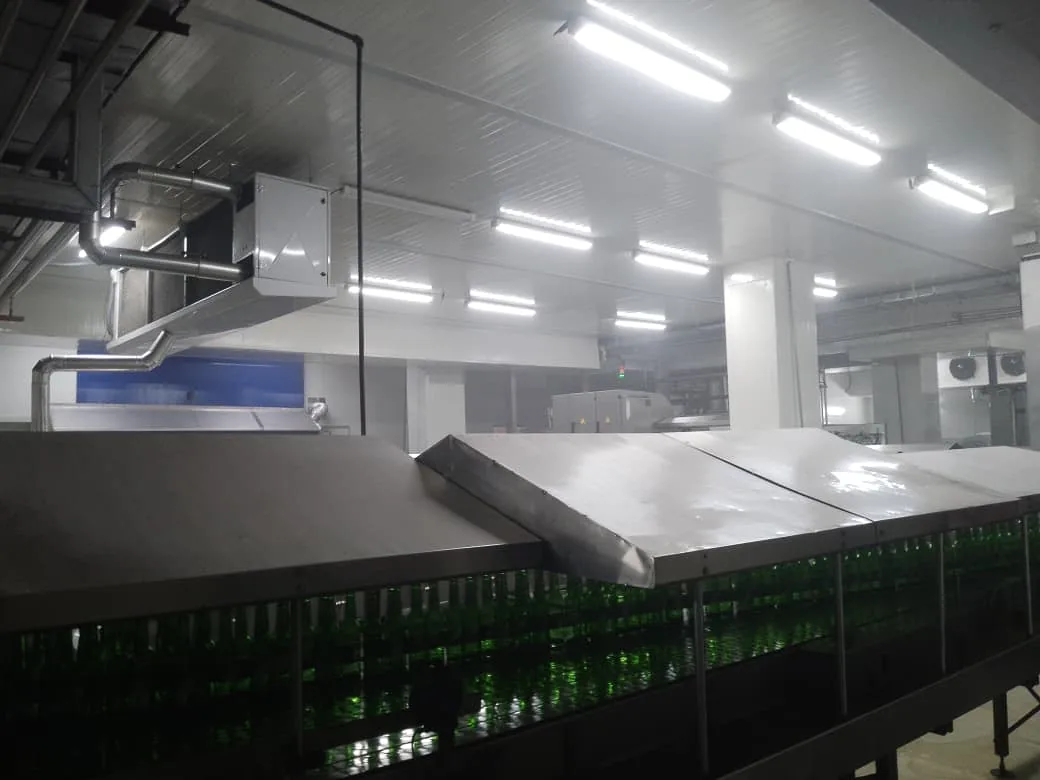 Wide view of the Lotte Akhtar Beverages plant floor under Crest LED lighting